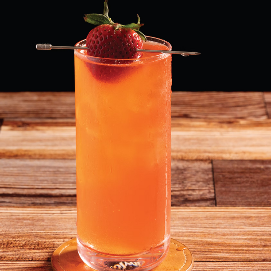 Kentucky Kiss bourbon cocktail with strawberry garnish in a highball glass.