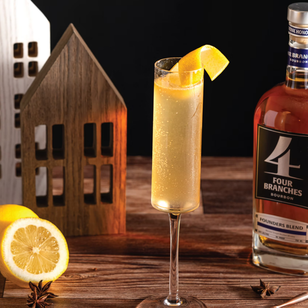 The Normandy bourbon cocktail with champagne and lemon twist, served in a flute glass.