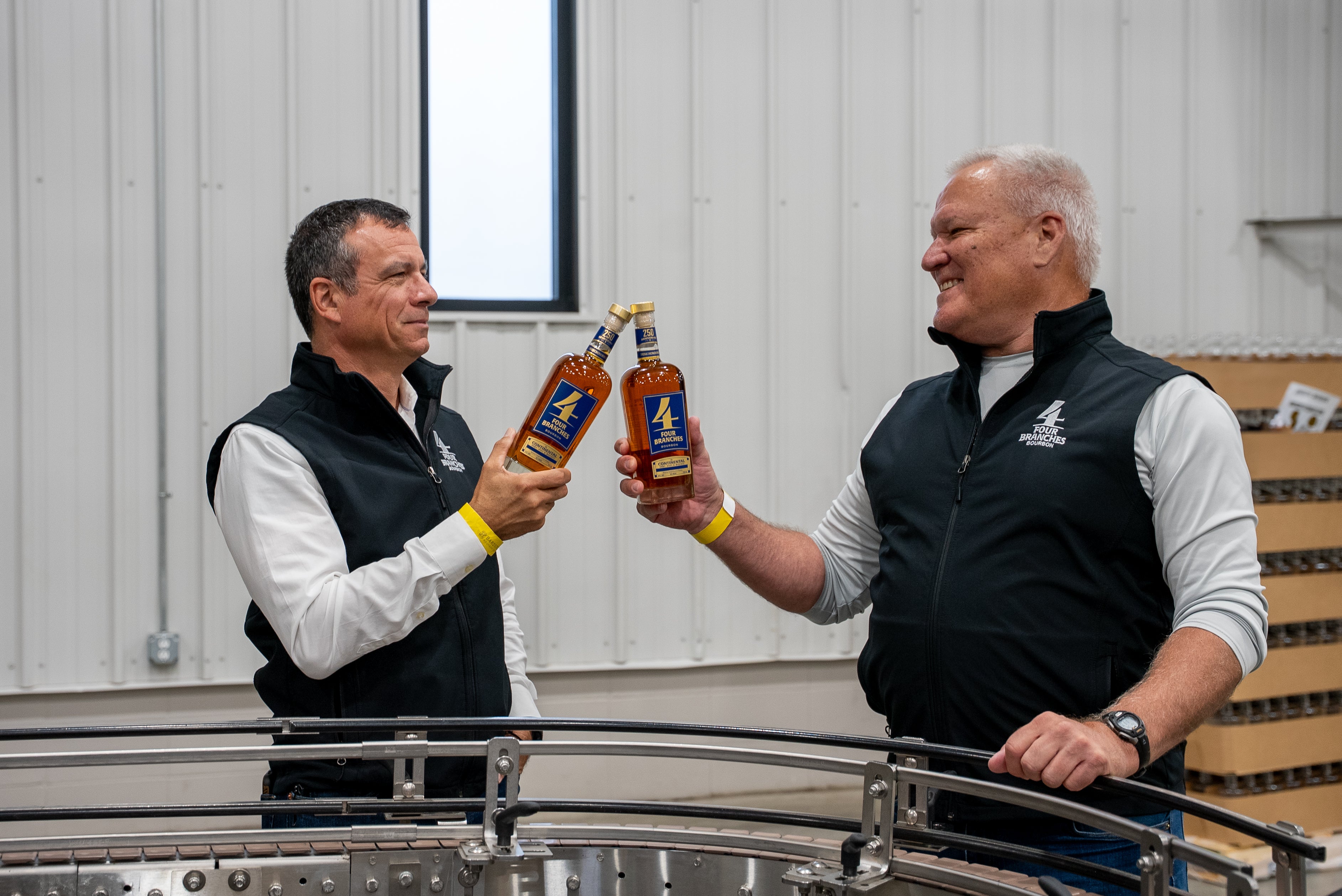 "Rick Franco, co-founder of Four Branches Bourbon, and Gregg Snyder, master distiller, overseeing The Continental bottling line to commemorate 250 years of U.S. military history."